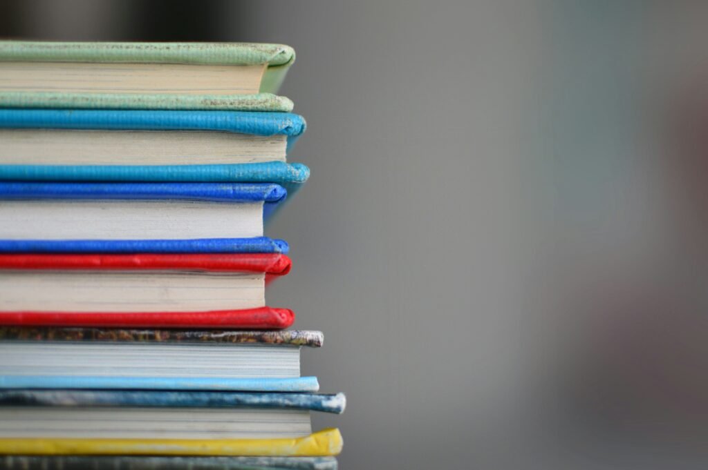Stack of educational books representing online teaching resources and learning materials